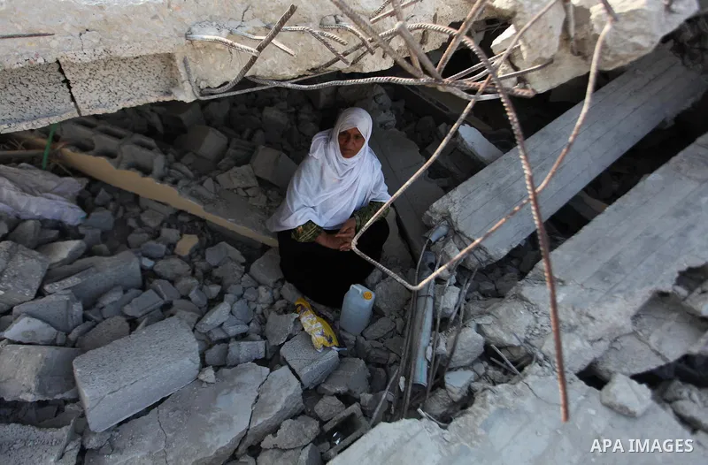 A Palestinian Bedouin sits on the rubble of her house which destroyed during fighting between Hamas militants and Israel in the center of Gaza strip on September 08, 2014. Calm returned to the coastal enclave in a August...