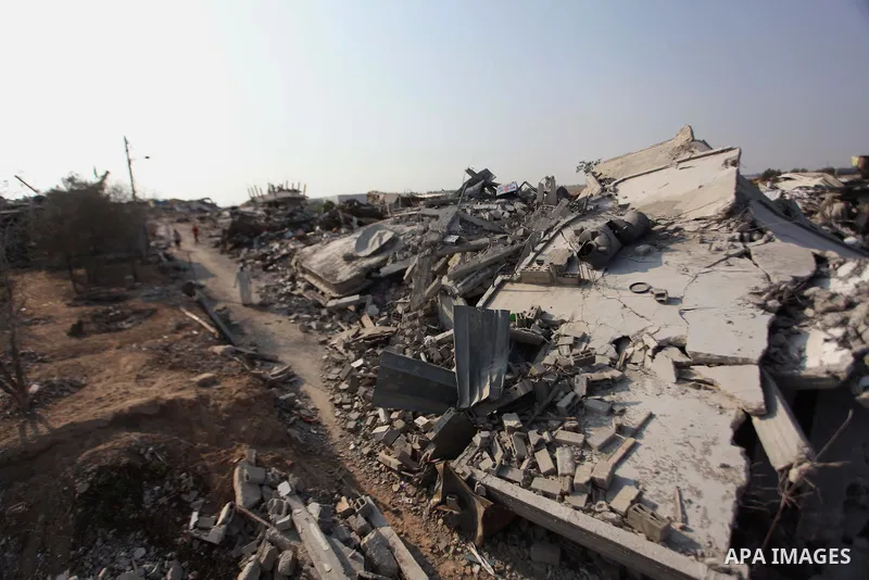 Palestinians gather around the rubble of his house which destroyed during fighting between Hamas militants and Israel in the center of Gaza strip on September 08, 2014. Calm returned to the coastal enclave in a August 26...