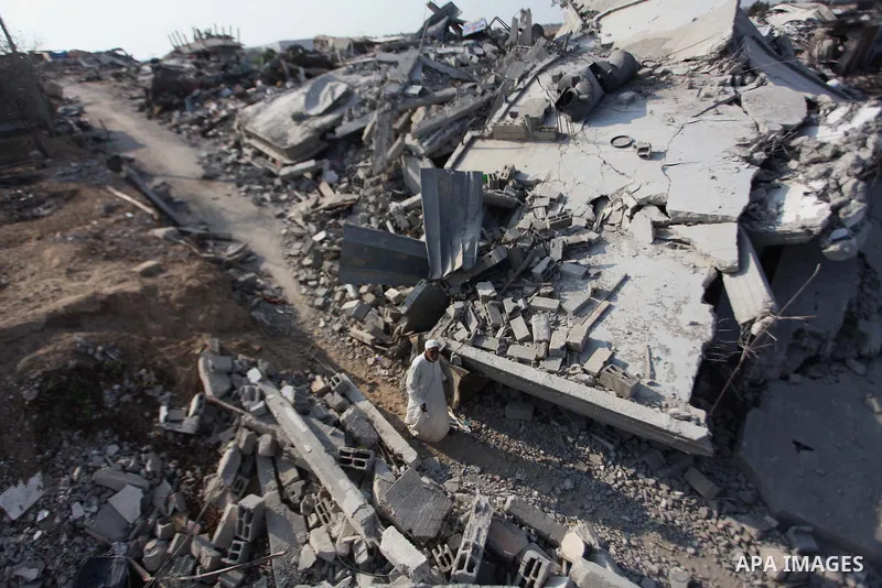 A Palestinian man stands on the rubble of her house which destroyed during fighting between Hamas militants and Israel in the center of Gaza strip on September 08, 2014. Calm returned to the coastal enclave in a August 2...