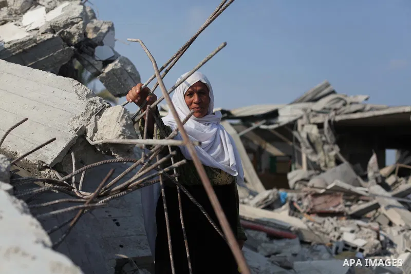 A Palestinian Bedouin sits on the rubble of her house which destroyed during fighting between Hamas militants and Israel in the center of Gaza strip on September 08, 2014. Calm returned to the coastal enclave in a August...