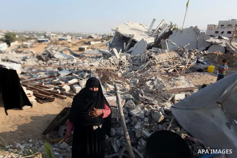 A Palestinian Bedouin stands on the rubble of her house which destroyed during fighting between Hamas militants and Israel in the center of Gaza strip on September 08, 2014. Calm returned to the coastal enclave in a Augu...