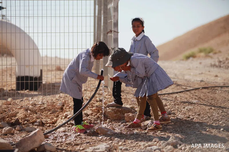 Palestinian Bedouin Students drink water at Arab Al-Ka'abneh school in Al-Mu'arrajat area near the West Bank city of Jericho, on Sep. 08, 2014. Dozens of Palestinian children in the ramshackle Bedouin community outside J...