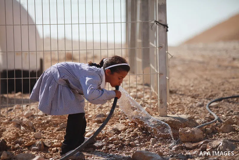 A Palestinian Bedouin Student drinks water at Arab Al-Ka'abneh school in Al-Mu'arrajat area near the West Bank city of Jericho, on Sep. 08, 2014. Dozens of Palestinian children in the ramshackle Bedouin community outside...