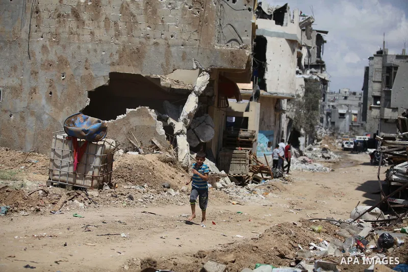 A Palestinian boy walks past the houses which destroyed during fighting between Hamas militants and Israel at Al-Shojae'ya neighborhood east of Gaza City, on Sep. 08, 2014. Briand is the first Minister visited Gaza strip...