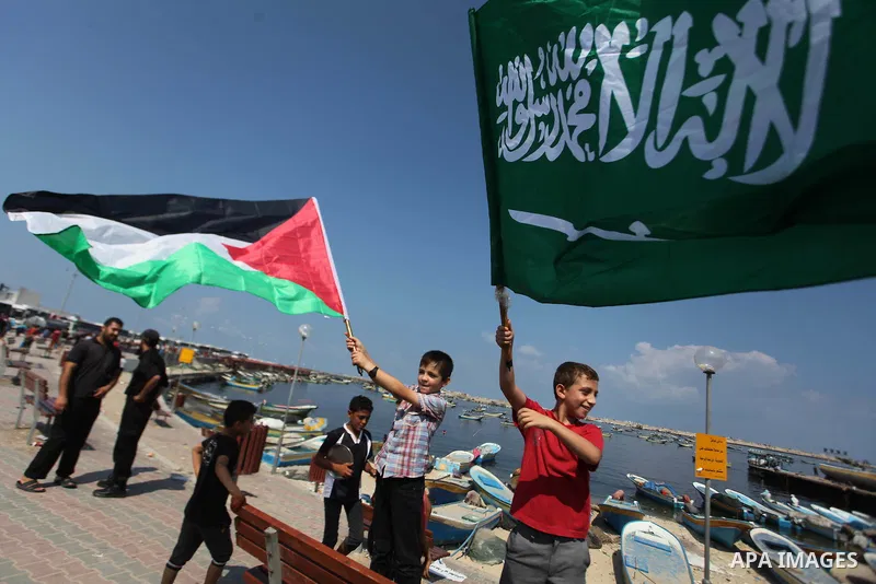 Palestinian children hold flags and banners during a rally to demand break the Israeli blockade on the Gaza strip, in Gaza's seaport on Sep. 08, 2014. Calm returned to the coastal enclave in a August 26 ceasefire, and Ga...