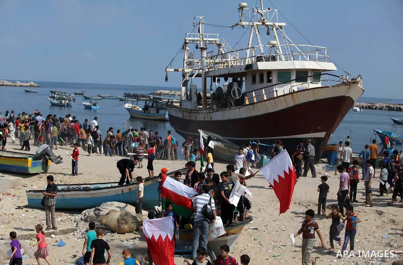 Palestinian children hold flags and banners during a rally to demand break the Israeli blockade on the Gaza strip, in Gaza's seaport on Sep. 08, 2014. Calm returned to the coastal enclave in a August 26 ceasefire, and Ga...