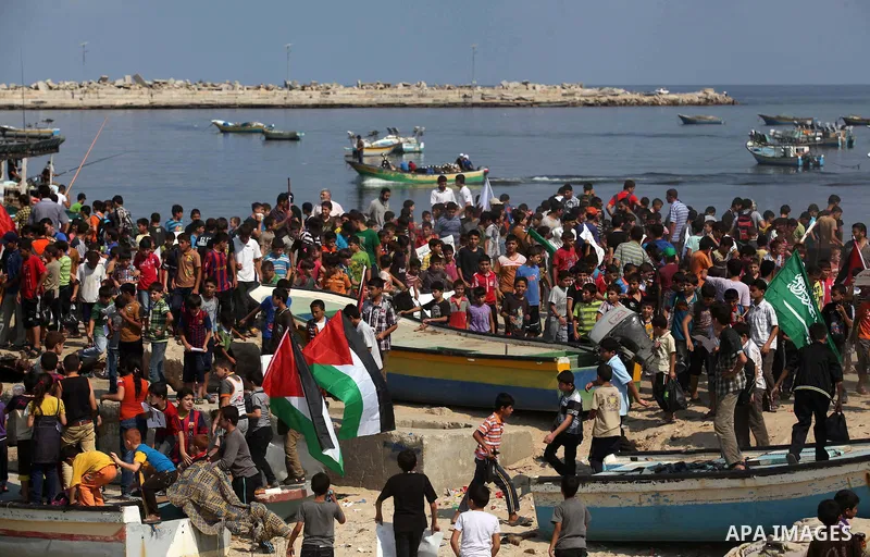Palestinian children hold flags and banners during a rally to demand break the Israeli blockade on the Gaza strip, in Gaza's seaport on Sep. 08, 2014. Calm returned to the coastal enclave in a August 26 ceasefire, and Ga...