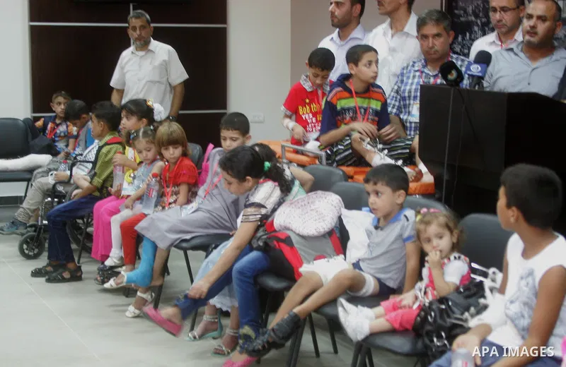 Palestinian childern, who medics said were wounded during the Israeli offensive on Gaza Strip, wait to be given the permission to cross into Egypt at the Rafah border crossing in the southern Gaza Strip, on Sep. 08, 2014...