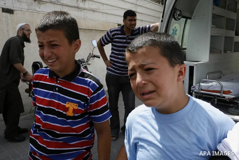 The brothers of Saleh al-Riyati, who witnesses said was killed in an Israeli air strike, mourn during his funeral oustide Abu Yousef al-Najjar hospital, in Rafah in the southern in Gaza city, on Sep. 10, 2014. Photo by A...