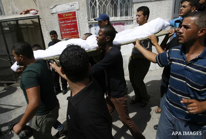 Palestinians carry the body of Saleh al-Riyati, who witnesses said was killed in an Israeli air strike, during his funeral at Abu Yousef al-Najjar hospital, in Rafah in the southern in Gaza city, on Sep. 10, 2014. Photo...