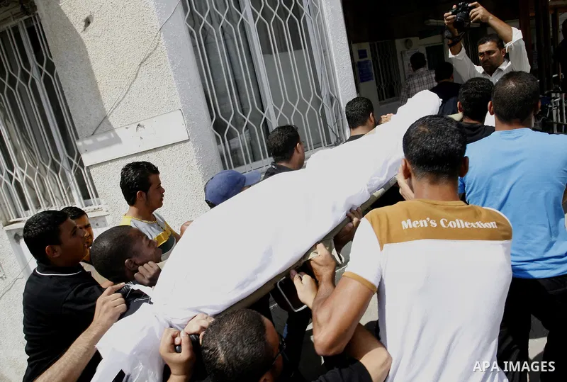 Palestinians carry the body of Saleh al-Riyati, who witnesses said was killed in an Israeli air strike, during his funeral at Abu Yousef al-Najjar hospital, in Rafah in the southern in Gaza city, on Sep. 10, 2014. Photo...