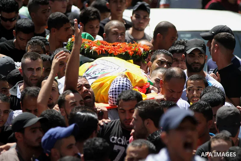 Palestinian Mourners carry the body of Palestinian Eissa al-Qotri, 22, during his funeral at al-Amari refugee camp, in the West Bank city of Ramallah, on Sep. 10, 2014. Al-Qatari was shot during clashes between young Pal...