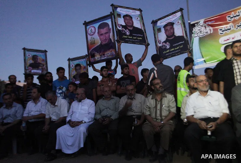 Palestinians hold pictures of their relatives who were killed during the Israeli offensive during the visit of Senior leader of Hamas Ismail Haniyeh in the Deir al-Balah in the central Gaza Strip, on September 10, 2014....
