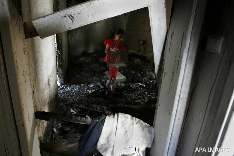 A Palestinian girl searches in a destroyed house in Khan Yunis in the southern Gaza Strip on September 11, 2014. Israel's deputy foreign minister,Tzahi Hanegbi , warned that Hamas was likely to resume "violence" if it fe...