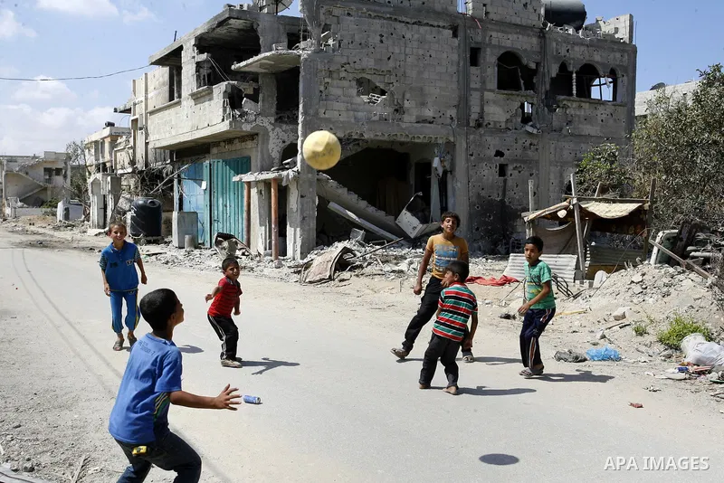 Palestinian children play near a destroyed house in Khan Yunis in the southern Gaza Strip on September 11, 2014. Israel's deputy foreign minister,Tzahi Hanegbi , warned that Hamas was likely to resume "violence" if it fe...