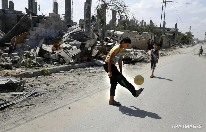 Palestinian children play near a destroyed house in Khan Yunis in the southern Gaza Strip on September 11, 2014. Israel's deputy foreign minister,Tzahi Hanegbi , warned that Hamas was likely to resume "violence" if it fe...