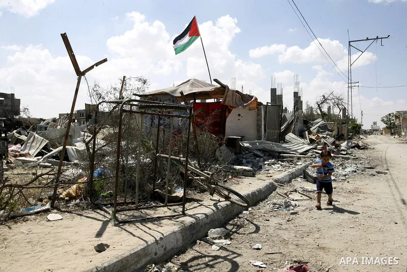 A Palestinian boy plays near a destroyed house in Khan Yunis in the southern Gaza Strip on September 11, 2014. Israel's deputy foreign minister,Tzahi Hanegbi , warned that Hamas was likely to resume "violence" if it feel...
