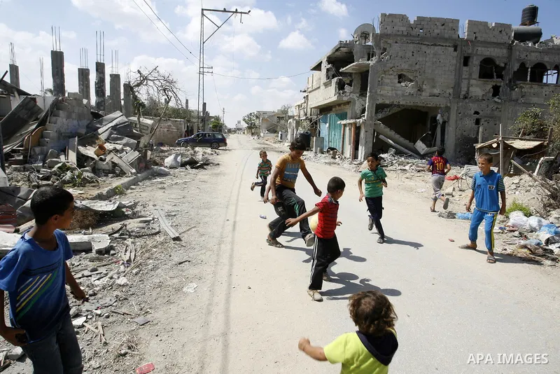 Palestinian children play near a destroyed house in Khan Yunis in the southern Gaza Strip on September 11, 2014. Israel's deputy foreign minister,Tzahi Hanegbi , warned that Hamas was likely to resume "violence" if it fe...
