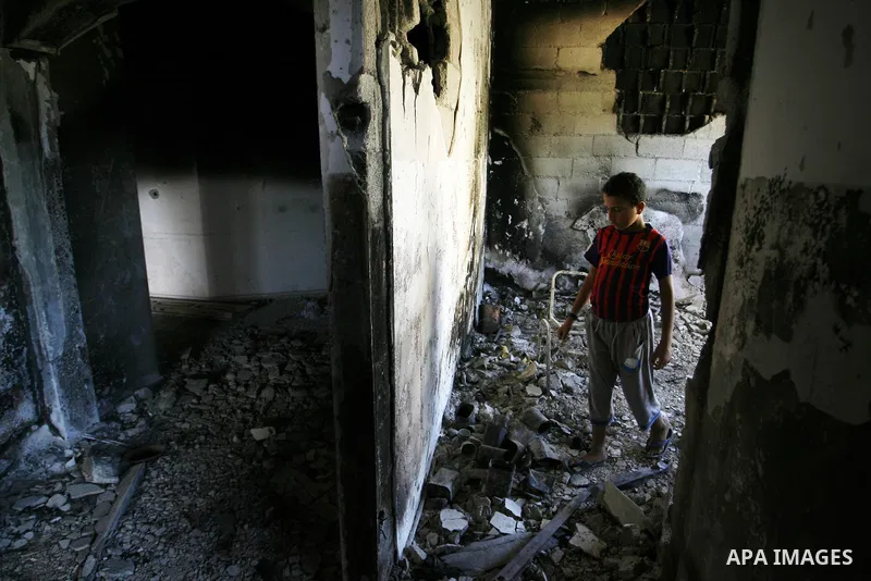 A Palestinian boy searches in a destroyed house in Khan Yunis in the southern Gaza Strip on September 11, 2014. Israel's deputy foreign minister,Tzahi Hanegbi , warned that Hamas was likely to resume "violence" if it fee...