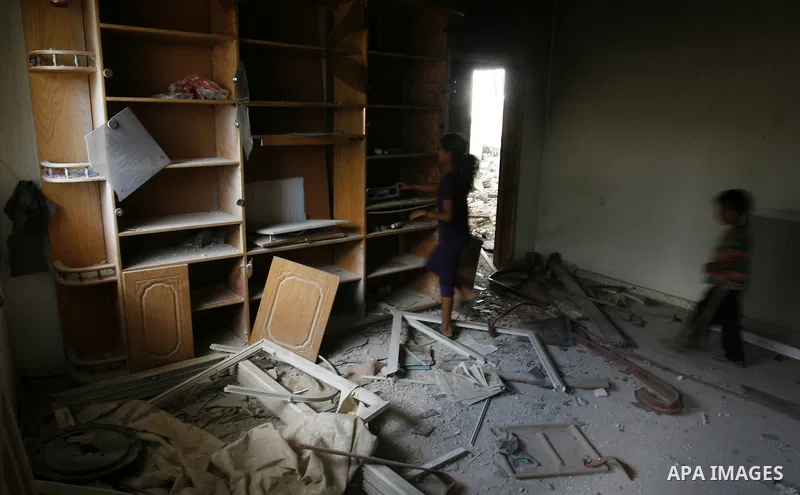 Palestinian children search in a destroyed house in Khan Yunis in the southern Gaza Strip on September 11, 2014. Israel's deputy foreign minister,Tzahi Hanegbi , warned that Hamas was likely to resume "violence" if it fe...