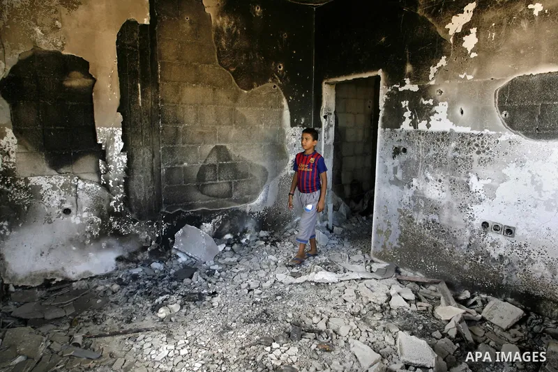 A Palestinian boy searches in a destroyed house in Khan Yunis in the southern Gaza Strip on September 11, 2014. Israel's deputy foreign minister,Tzahi Hanegbi , warned that Hamas was likely to resume "violence" if it fee...