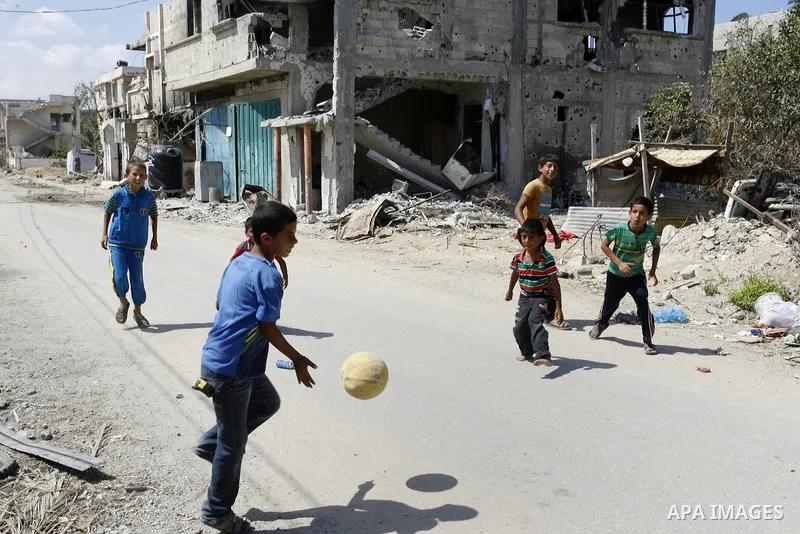 Palestinian children play near a destroyed house in Khan Yunis in the southern Gaza Strip on September 11, 2014. Israel's deputy foreign minister,Tzahi Hanegbi , warned that Hamas was likely to resume "violence" if it fe...
