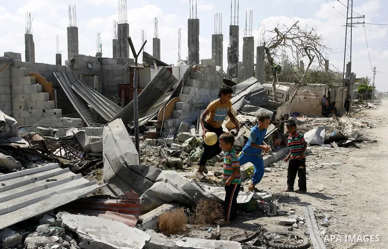 Palestinian children play near a destroyed house in Khan Yunis in the southern Gaza Strip on September 11, 2014. Israel's deputy foreign minister,Tzahi Hanegbi , warned that Hamas was likely to resume "violence" if it fe...