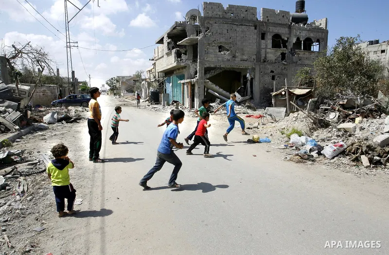 Palestinian children play near a destroyed house in Khan Yunis in the southern Gaza Strip on September 11, 2014. Israel's deputy foreign minister,Tzahi Hanegbi , warned that Hamas was likely to resume "violence" if it fe...