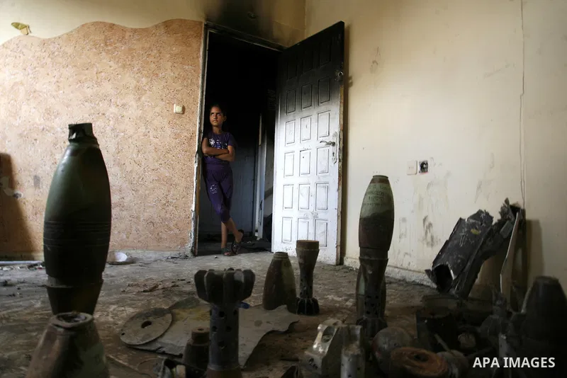 A Palestinian girl looks at mortars and spent ammunition that, Suleiman Abu Jamaa, 35, collected around his destroyed home in Khan Yunis in the southern Gaza Strip on September 11, 2014. Israel's deputy foreign minister,...