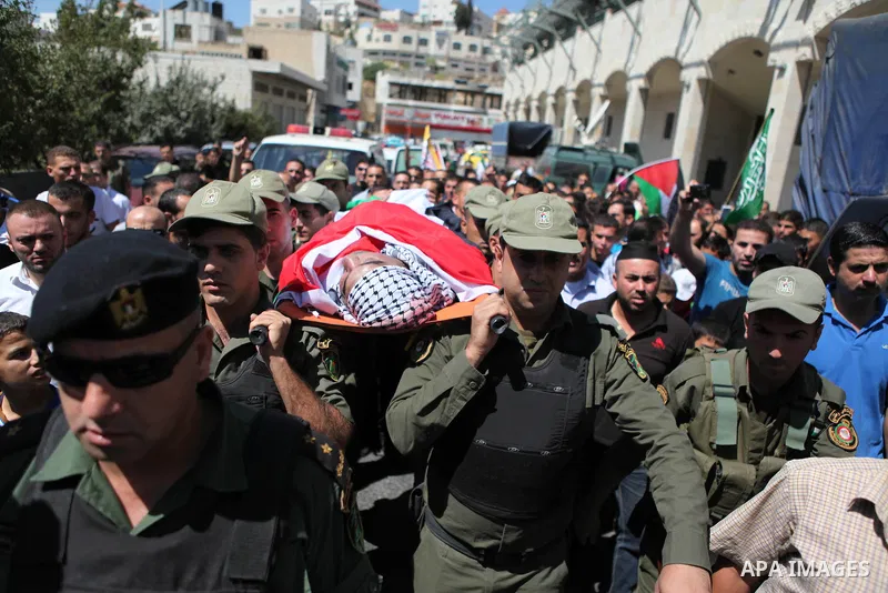 Palestinian security forces carry the body of Raed al-Jabari, 35, during his funeral in the West Bank city of Hebron, September 12, 2014. Al-Jabari died on Tuesday in Israel's Soroka Medical Center after Palestinian offi...
