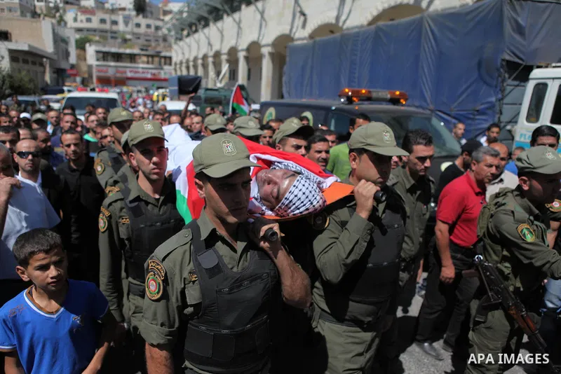 Palestinian security forces carry the body of Raed al-Jabari, 35, during his funeral in the West Bank city of Hebron, September 12, 2014. Al-Jabari died on Tuesday in Israel's Soroka Medical Center after Palestinian offi...