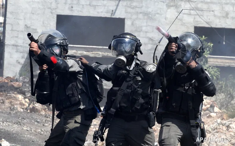 Israeli security forces fire tear gas towards Palestinian protesters during clashes following a protest in the village of Kfar Qaddum, near the northern city of Nablus, in the occupied West Bank on September 12, 2014. Ph...