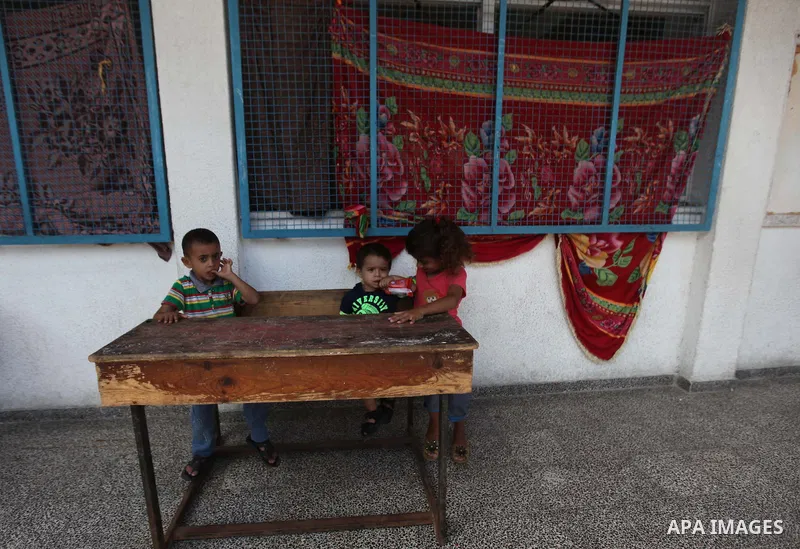 Displaced Palestinians shelter at a United Nations-run school, in Gaza city, on Sept. 13, 2014. Some 34 school buildings in Gaza are damaged beyond repair and 31 more are still being used as shelters, while Gaza prepare...