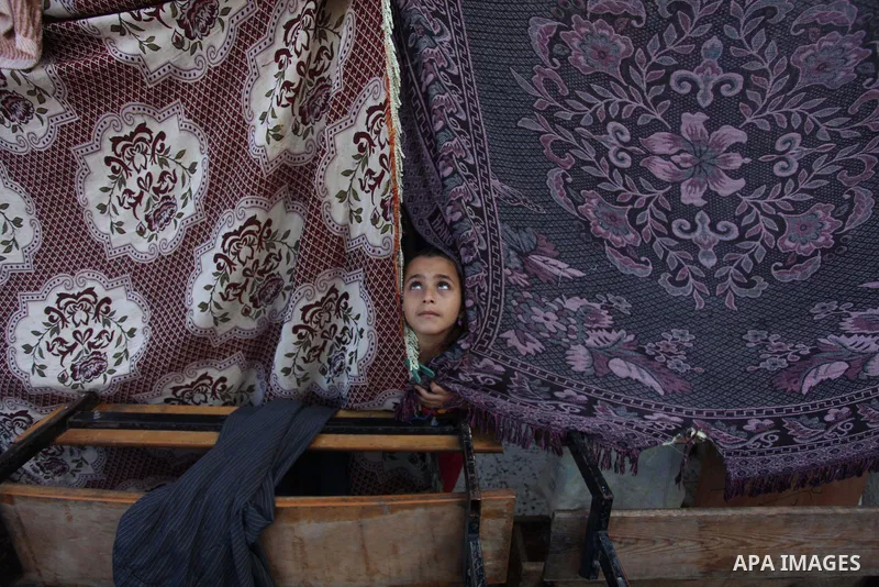 Displaced Palestinians shelter at a United Nations-run school, in Gaza city, on Sept. 13, 2014. Some 34 school buildings in Gaza are damaged beyond repair and 31 more are still being used as shelters, while Gaza prepare...