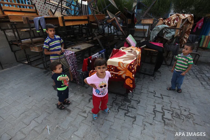 Displaced Palestinians shelter at a United Nations-run school, in Gaza city, on Sept. 13, 2014. Some 34 school buildings in Gaza are damaged beyond repair and 31 more are still being used as shelters, while Gaza prepare...