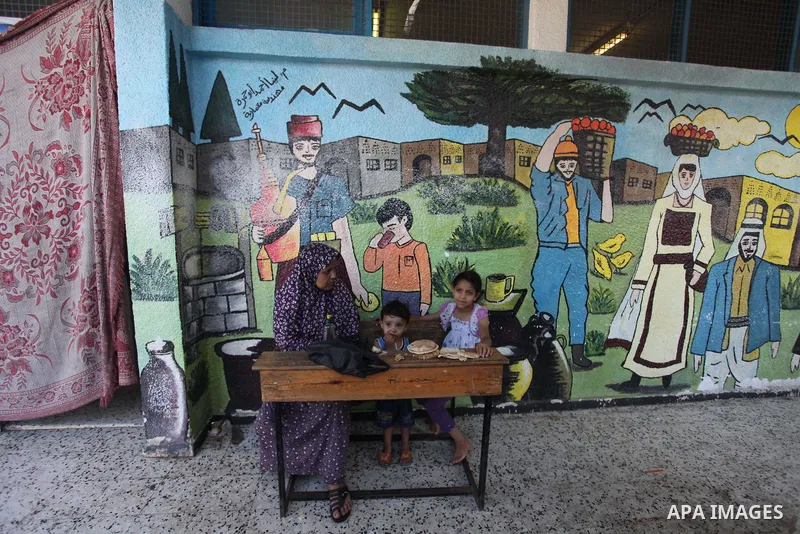 Displaced Palestinians shelter at a United Nations-run school, in Gaza city, on Sept. 13, 2014. Some 34 school buildings in Gaza are damaged beyond repair and 31 more are still being used as shelters, while Gaza prepare...