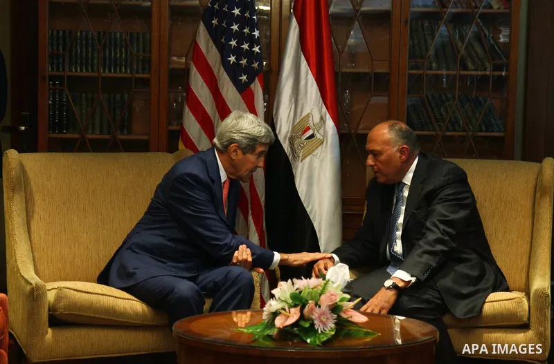 U.S. Secretary of State John Kerry, left, talks to Egypt's Foreign Minister Sameh Shukri, in Cairo, Egypt, Saturday, Sept. 13, 2014. Kerry is in Cairo as part of a regional tour to build support for President Barack Obam...