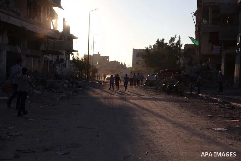 Palestinian students walk past houses that witnesses said were destroyed by the Israeli offensive, as they make their way to school on the first day of the new school year in the east of Gaza City September 14, 2014. An...