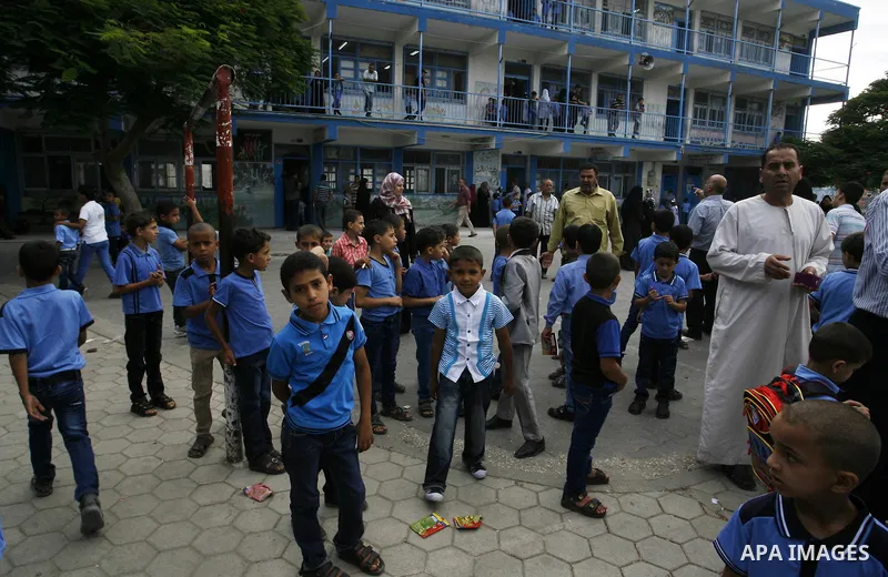 Palestinian students stand inside their a United Nations-run school, on the first day of the new school year in Rafah refugee camp in the southern Gaza Strip September 14, 2014. An open-ended ceasefire between Israel and...