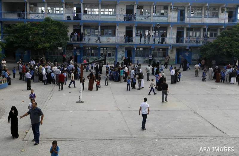 Palestinian students stand inside their a United Nations-run school, on the first day of the new school year in Rafah refugee camp in the southern Gaza Strip September 14, 2014. An open-ended ceasefire between Israel and...