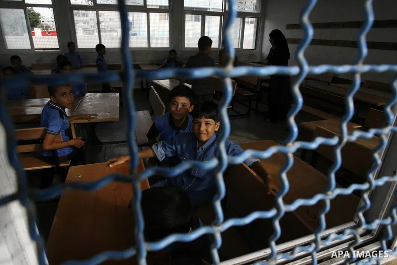 Palestinian students sit inside a class at a United Nations-run school, in Rafah refugee camp in the southern Gaza Strip September 14, 2014 on the first day of the new school year. An open-ended ceasefire between Israel...