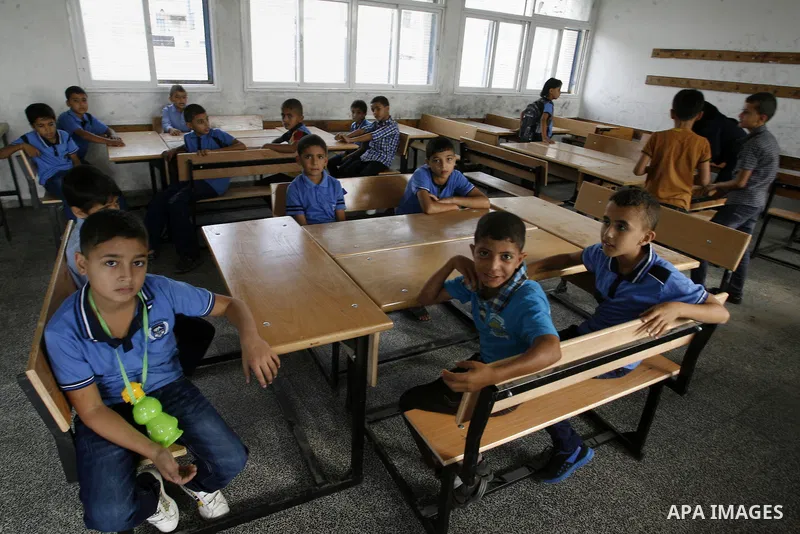 Palestinian students sit inside a class at a United Nations-run school, in Rafah refugee camp in the southern Gaza Strip September 14, 2014 on the first day of the new school year. An open-ended ceasefire between Israel...