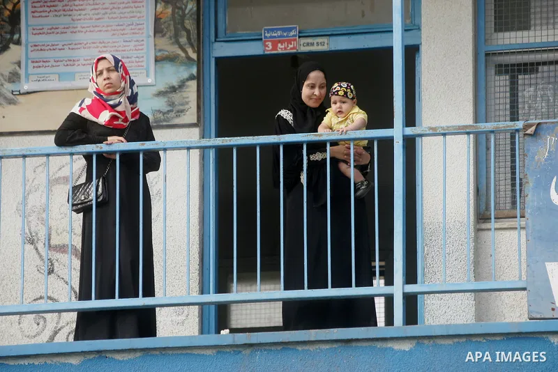Palestinians stand inside a United Nations-run school, on the first day of the new school year in Rafah refugee camp in the southern Gaza Strip September 14, 2014. An open-ended ceasefire between Israel and Hamas-led Gaz...
