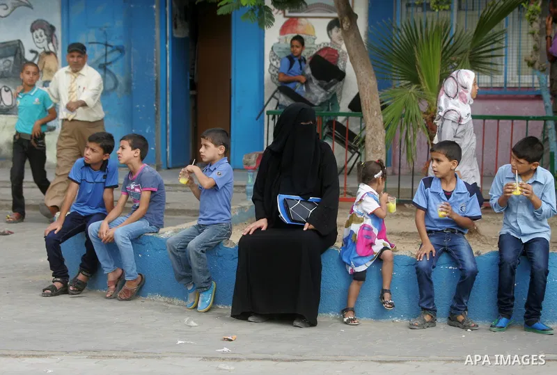 Palestinian students sit inside their a United Nations-run school, on the first day of the new school year in Rafah refugee camp in the southern Gaza Strip September 14, 2014. An open-ended ceasefire between Israel and H...