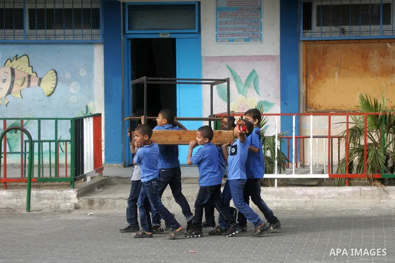 Palestinian students stand inside their a United Nations-run school, on the first day of the new school year in Rafah refugee camp in the southern Gaza Strip September 14, 2014. An open-ended ceasefire between Israel and...