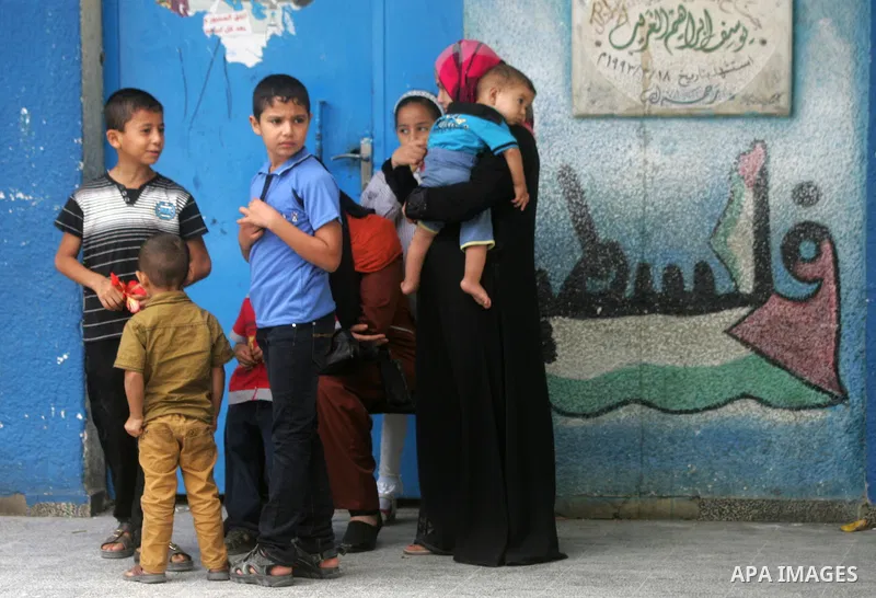 Palestinian students stand inside their a United Nations-run school, on the first day of the new school year in Rafah refugee camp in the southern Gaza Strip September 14, 2014. An open-ended ceasefire between Israel and...