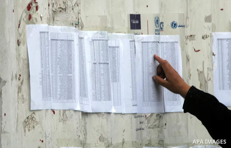 Palestinian students search on their names at a United Nations-run school, on the first day of the new school year in Rafah refugee camp in the southern Gaza Strip September 14, 2014. An open-ended ceasefire between Isra...