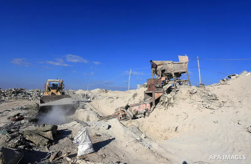 Palestinian workers smash large stones into small gravels to be used for building houses that witnesses said were destroyed by Israel during its offensive, in Gaza City September 14, 2014. An open-ended ceasefire between...
