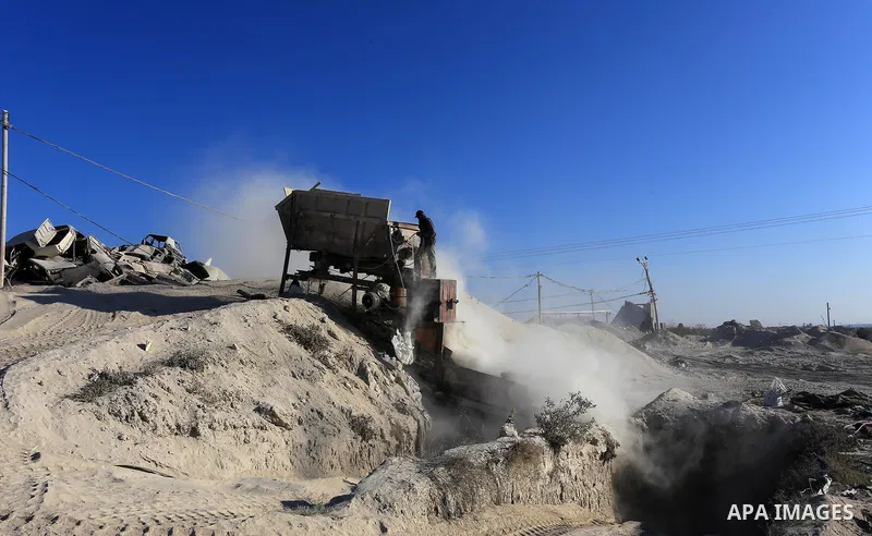 Palestinian workers smash large stones into small gravels to be used for building houses that witnesses said were destroyed by Israel during its offensive, in Gaza City September 14, 2014. An open-ended ceasefire between...