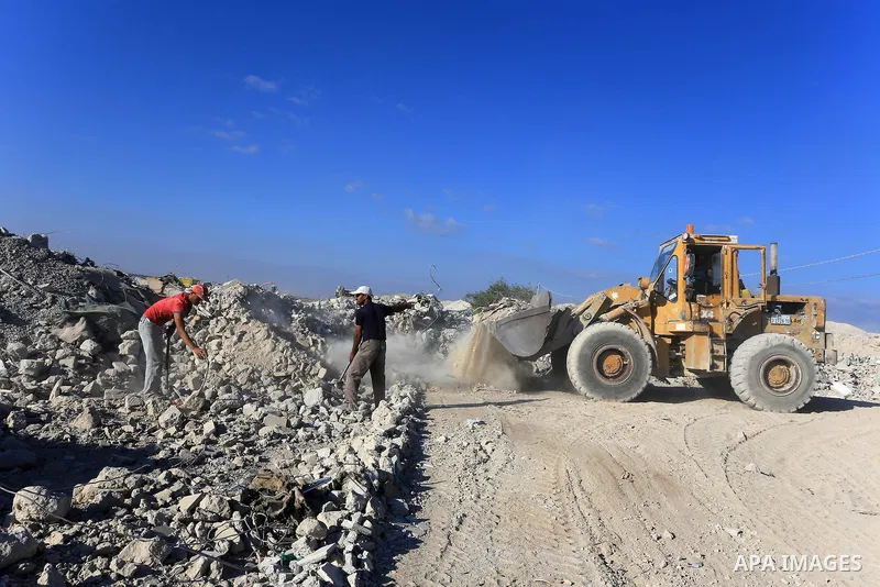 Palestinian workers smash large stones into small gravels to be used for building houses that witnesses said were destroyed by Israel during its offensive, in Gaza City September 14, 2014. An open-ended ceasefire between...